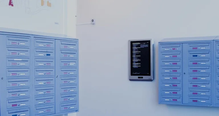 Brevlådor och en informationsskärm i ett trapphus